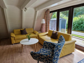 Wooden bungalow with a terrace, in a wooded area